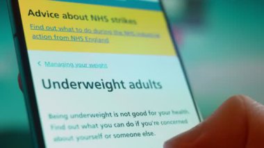 Smartphone in hand, looking for information about overweight.
