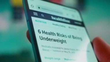 Smartphone in hand, looking for information about overweight.