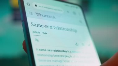 Smartphone in hand, looking for information about same sex.