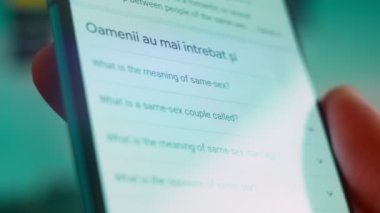 Smartphone in hand, looking for information about same sex.