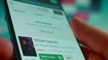 Smartphone in hand, looking for information about white smoke.