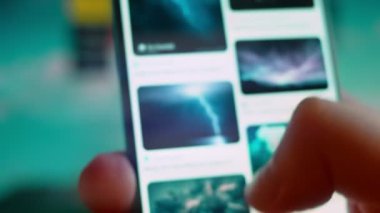 Smartphone in hand, looking for information about lightning sky.