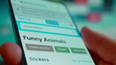 Smartphone in hand, looking for information about funny animals.