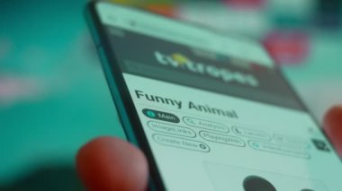 Smartphone in hand, looking for information about funny animals.