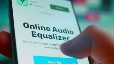 Smartphone in hand, looking for information about music equalizer.