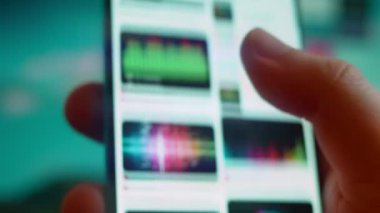 Smartphone in hand, looking for information about music equalizer.