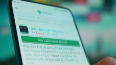 Smartphone in hand, looking for information about music equalizer.