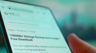 Smartphone in hand, Im looking for information on the internet about vintage background.