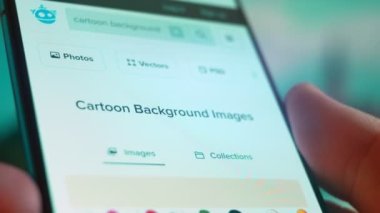 Smartphone in hand, Im looking for information on the internet about cartoon background.