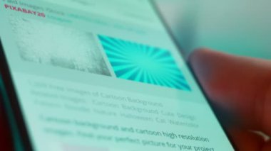 Smartphone in hand, Im looking for information on the internet about cartoon background.