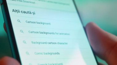 Smartphone in hand, Im looking for information on the internet about cartoon background.