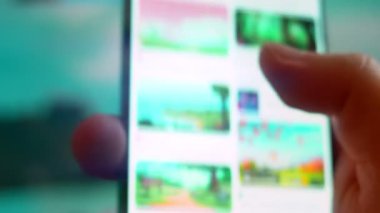 Smartphone in hand, Im looking for information on the internet about cartoon background.