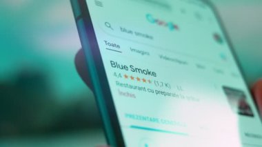 Smartphone in hand, Im looking for information on the internet about blue smoke.