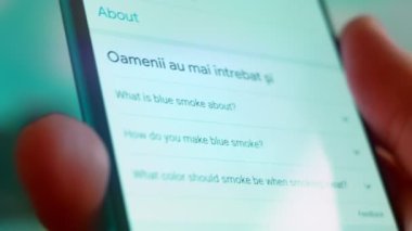 Smartphone in hand, Im looking for information on the internet about blue smoke.