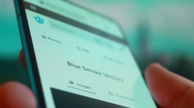 Smartphone in hand, Im looking for information on the internet about blue smoke.