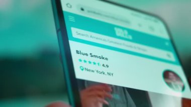 Smartphone in hand, Im looking for information on the internet about blue smoke.