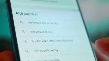 Smartphone in hand, Im looking for information on the Internet about film scratches.