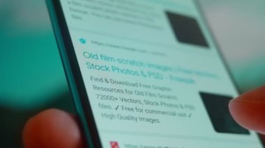 Smartphone in hand, Im looking for information on the Internet about film scratches.