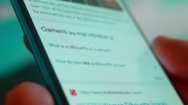 Smartphone in hand, Im looking for information on the internet about silhouette woman.