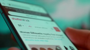 Smartphone in hand, Im looking for information on the internet about silhouette woman.