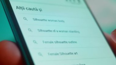 Smartphone in hand, Im looking for information on the internet about silhouette woman.