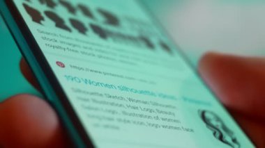 Smartphone in hand, Im looking for information on the internet about silhouette woman.