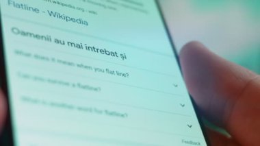 Smartphone in hand, Im looking for information on the internet about flat line.