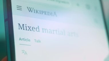 Smartphone in hand, looking for information about mixed fights.