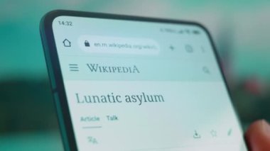 Smartphone in hand, looking for information about mental hospital.