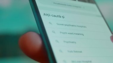 Smartphone in hand, looking for information about mental hospital.