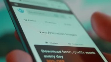 Smartphone in hand, looking for information about fire animation.