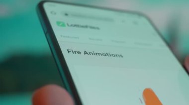 Smartphone in hand, looking for information about fire animation.