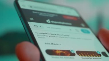 Smartphone in hand, looking for information about fire animation.