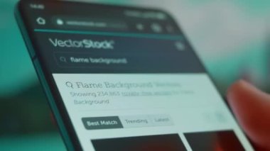 Smartphone in hand, looking for information about flame background.