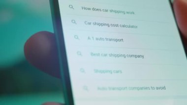 Smartphone in hand, looking for information about car moving.