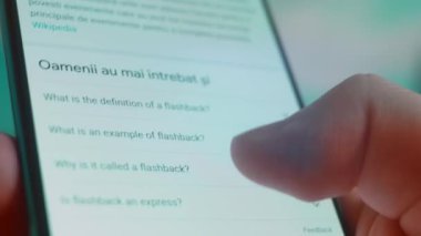 Smartphone in hand, looking for information about flashback.