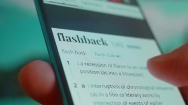 Smartphone in hand, looking for information about flashback.