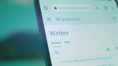 Smartphone in hand, looking for information about writers.