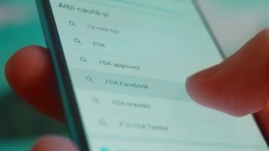 Smartphone in hand, looking for information about fda.