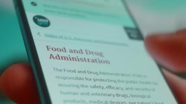 Smartphone in hand, looking for information about fda.