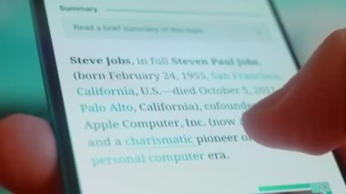 Smartphone in hand, looking for information about steve jobs.