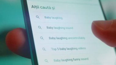 Smartphone in hand, looking for information about baby laughing.