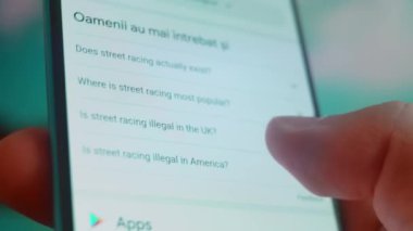 Smartphone in hand, looking for information about street racing.