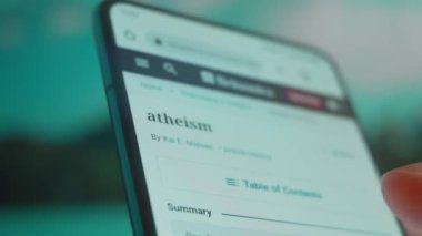 Smartphone in hand, looking for information about atheist.