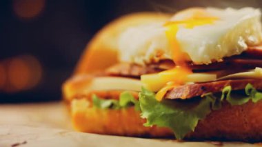 Fransız ekmeği, peynir, salata yaprakları ve sosisle sanvich 'in üzerinde kaynayan kalp şeklinde sahanda yumurta. Kaydırıcı atışı.