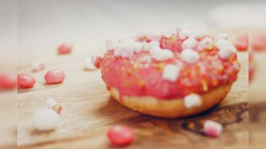 Marshmello ile süslenmiş pembe çörekler. Makro ve kaydırma atışı. Fırın ve yemek konsepti. Çeşitli renkli çörekler. Çikolata, pembe, mavi çörekler 4K, UHD.
