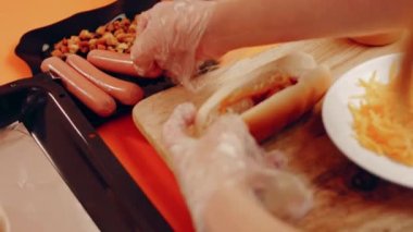 Process of preparing Irresistible chili cheese Hot Dogs. Taste USA cuisine.
