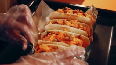 Process of preparing Irresistible chili cheese Hot Dogs. Taste USA cuisine.