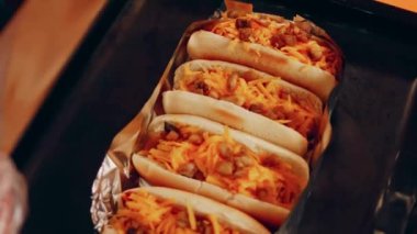 Process of preparing Irresistible chili cheese Hot Dogs. Taste USA cuisine.