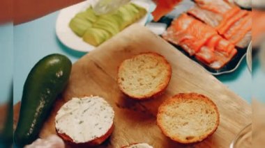 Preparing process of Cinematographic Smoked Salmon bagels. USA cusine.
